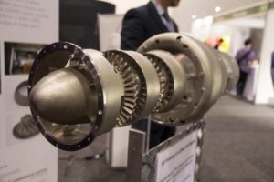 A 3D printed jet engine displayed on a stand.